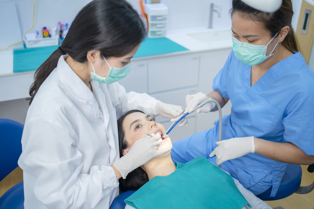 asian young dentist wearing face mask use medical 2021 12 09 20 28 23 utc 1