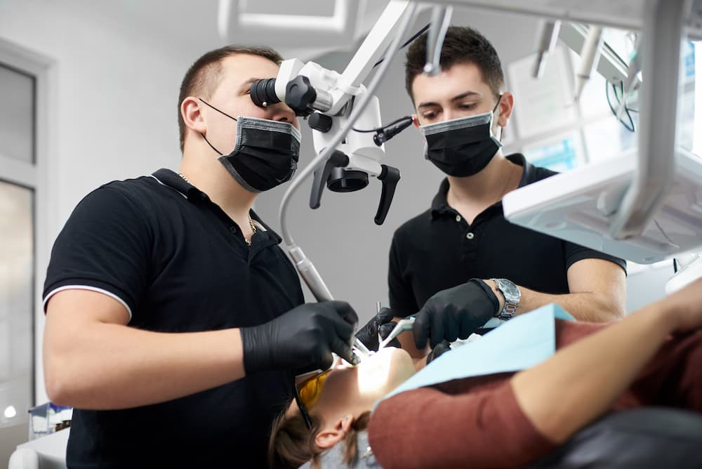 male dentist in a black uniform fixing patient s t 2022 05 13 01 03 48 utc 1