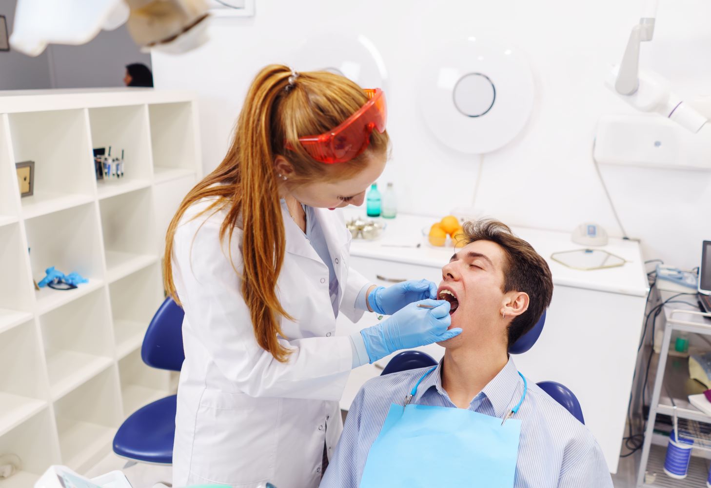 ginger dentist examining teeth of young patient 2022 01 20 19 48 07 utc 1